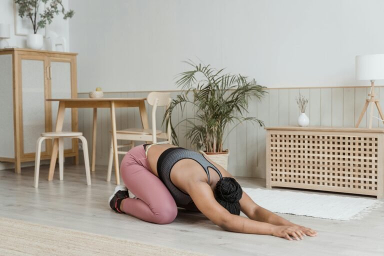 Young woman practicing yoga indoors in a stylish minimalist living space.